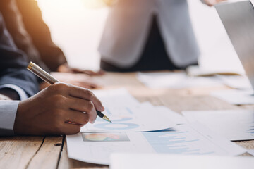 Brainstorming Collaboration and successful partnership analysis by Young business Asian people working in an office workspace