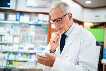 Pharmacist searching for a medicine while reading a prescription