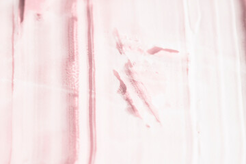 White cosmetic texture on a pink background, top view. Beauty product for care and moisturizing.