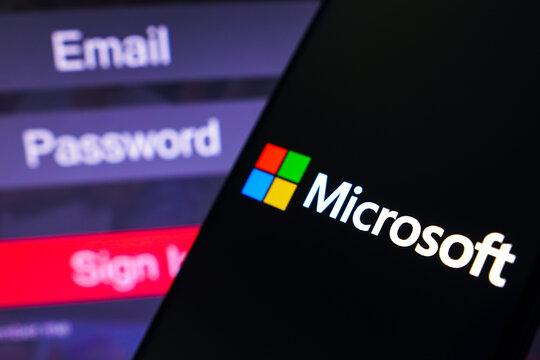 May 1, 2023, Brazil. In this photo illustration, the Microsoft Corporation logo is displayed on a smartphone screen, next to a login screen, with email, password and sign in.