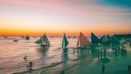 Aerial drone photos of Boracay in the Philippines during sunset, with a view of the sea and boats, during a sunny day