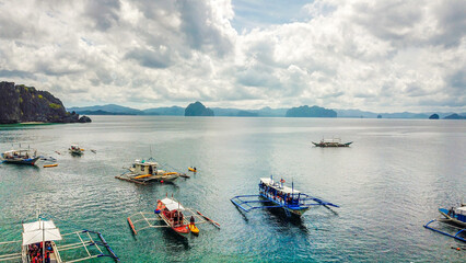 Fototapeta na wymiar Aerial photos with drone of the Nido in the Philippines, with a view of the islands, sea and boats, during a sunny day