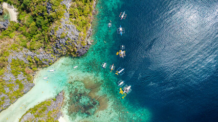 Aerial photos with drone of the Nido in the Philippines, with a view of the islands, sea and boats, during a sunny day
