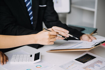 Financial analysts analyze business financial reports on a digital tablet planning investment project during a discussion at a meeting of corporate showing the results of their successful teamwork.