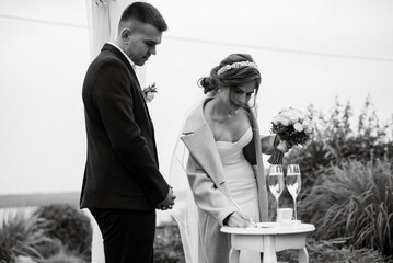 wedding ceremony of the newlyweds in a country cottage