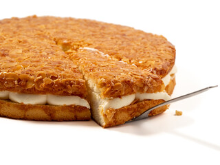 Bee sting cake, light cake with cream filling, with crispy almonds. Cake with almonds on a white background.