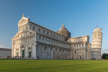The cathedral of Pisa and the leaning tower in the background during the afternoon. Tuscany, Italy