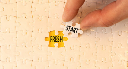 Fresh start and motivational symbol. Concept words Fresh start on white puzzles. Beautiful yellow table yellow background. Businessman hand. Business motivational and Fresh start concept. Copy space.