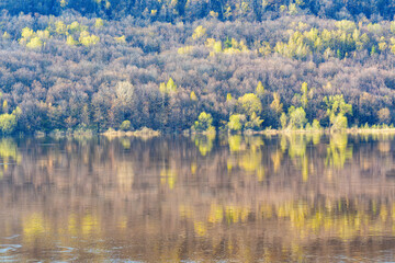 The hill is reflected in the river