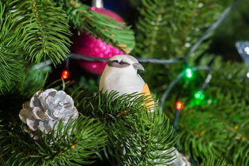 Russia. Kronstadt. January 19, 2023. Festive decoration toy birds and cones on the Christmas tree.