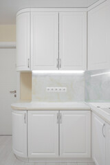 Facade of white kitchen furniture in the kitchen