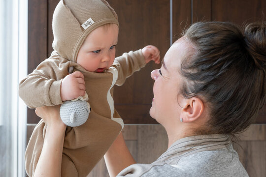 Mom Holding Infant In Her Arms Looking Out Window Parenthood Caring For Children Time Together Daily Home Domestic Routine Generative AI