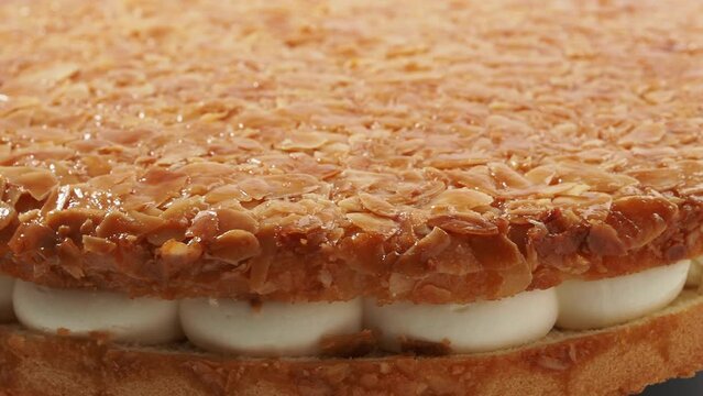 Bee sting cake, light cake with cream filling, with crispy almonds
