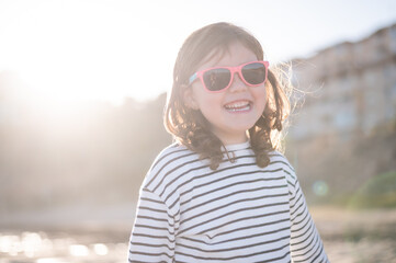 Happy girl in sunglasses on beach