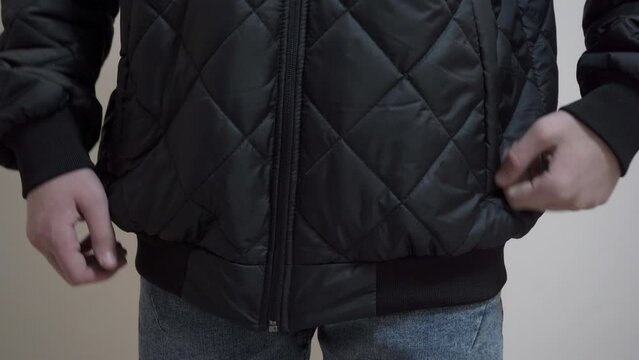 Boy Zipping Fastens  black Jacket With A Zipper,a teenager put on a black jacket