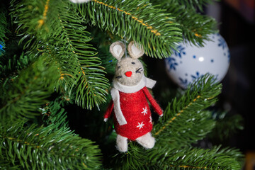 Russia. Kronstadt. January 19, 2023. Festive decoration - a mouse in a red coat on a Christmas tree.