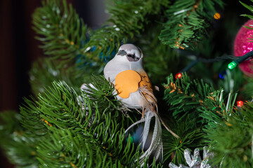 Russia. Kronstadt. January 19, 2023. Festive decoration toy birds and cones on the Christmas tree.