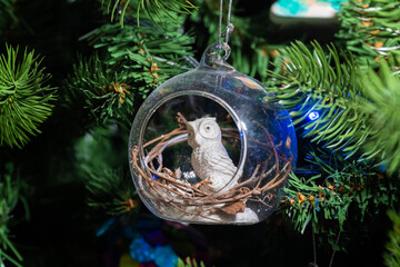 Russia. Kronstadt. January 19, 2023. Festive decoration owl in a ball on the Christmas tree.