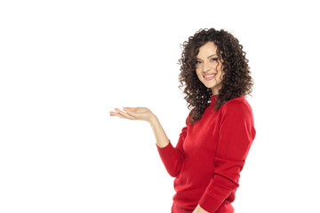 portrait of a young happy curly woman on a white background, advertise some product.
