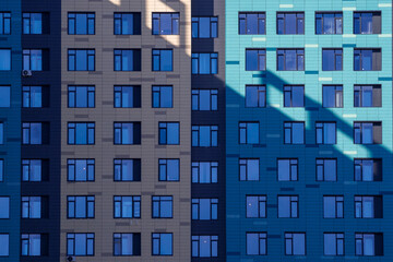 Windows on the ventilated facade of a typical modern residential building. Fragment of a new elite residential building or commercial complex