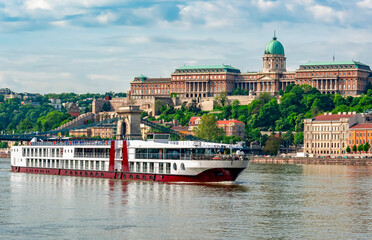 Cruise ship on Danube river with Royal palace at background, Budapest, Hungary