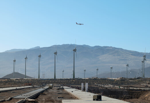Construction area with wind farm, mountains in the background. Location: Arinaga, Gran Canaria, Spain.