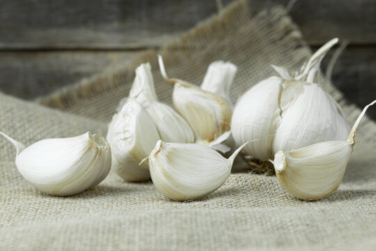 Fresh garlic close-up, cloves of garlic on a wooden background.