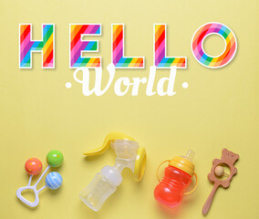 Banner with text HELLO WORLD and baby accessories