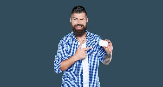 bearded man showing blank membership card with copy space