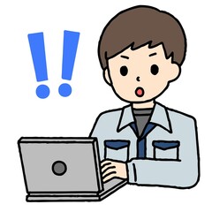 パソコン作業をする作業服の男性が驚いている