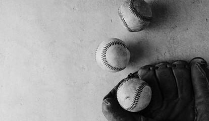 Old baseball balls used in game play on flat lay texture sports background with copy space in black and white.