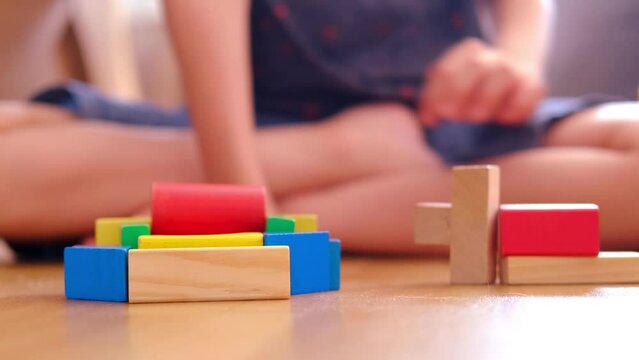 smart child, schoolboy playing with educational toy, wooden geometric figures, blocks in boy's hands, developing brain games, concept childhood, earlier child development, creativity, early training