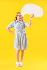 Thoughtful young woman with blank speech bubble on yellow background