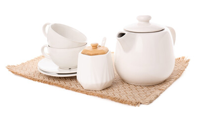 Fototapeta premium Wicker mat with teapot, sugar bowl and cups isolated on white background