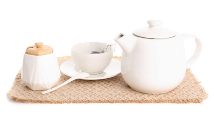 Wicker mat with teapot, sugar bowl and cup isolated on white background