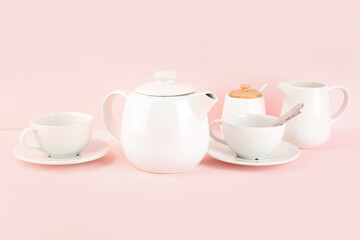Stylish tea set on pink background