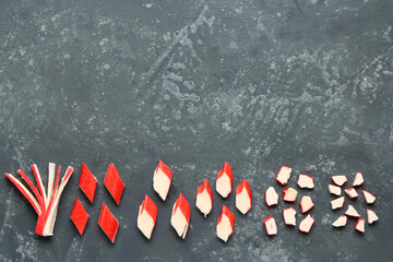 Pieces of tasty crab sticks on blue background © Pixel-Shot