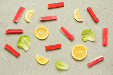 Tasty crab sticks, slices of lemon and lettuce on light background © Pixel-Shot
