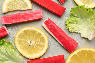 Tasty crab sticks, slices of lemon and lettuce on light background, closeup © Pixel-Shot