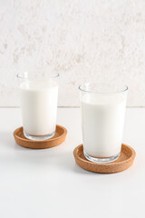 Glasses with fresh milk on white background