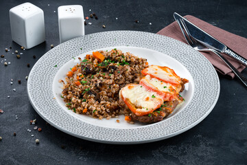 Fried beef with tomatoes and cheese and buckwheat porridge with mushrooms, onions, carrots and herbs.
