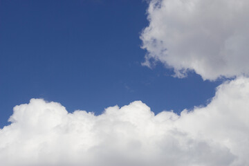 Naklejka na ściany i meble blue sky with puffy fluffy clouds in sunny day