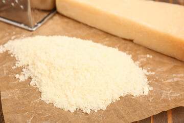 Tasty grated Parmesan cheese on table, closeup