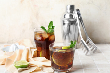 Glasses of tasty Cuba Libre cocktail on table