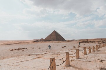 Majestic Pyramids of Egypt rise proudly against the vast desert landscape, a timeless testament to ancient civilization's architectural brilliance