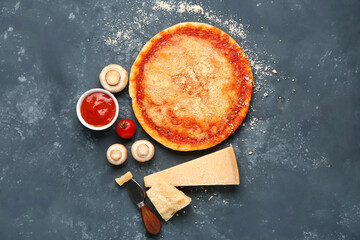 Tasty pizza with parmesan cheese and sauce on blue grunge background