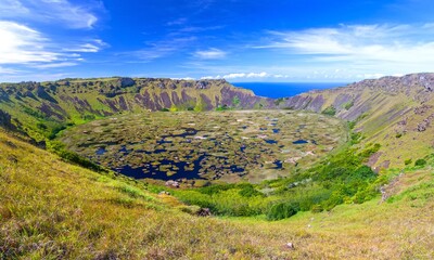 Rano Kau Extinct Volcano Crater Rim Panoramic Landscape with Green Wetland and Distant Pacific Ocean Horizon. Unesco World Heritage Site, Easter Island Rapa Nui, Chile