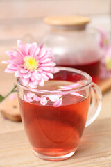 Beautiful tea set with chrysanthemums on wooden table