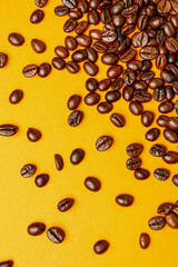 Scattered coffee beans on orange background
