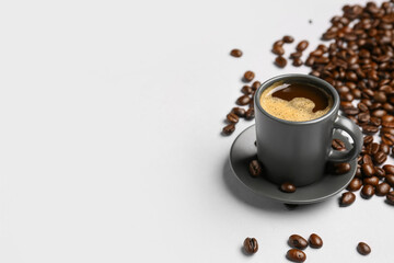 Cup of coffee and beans on grey background